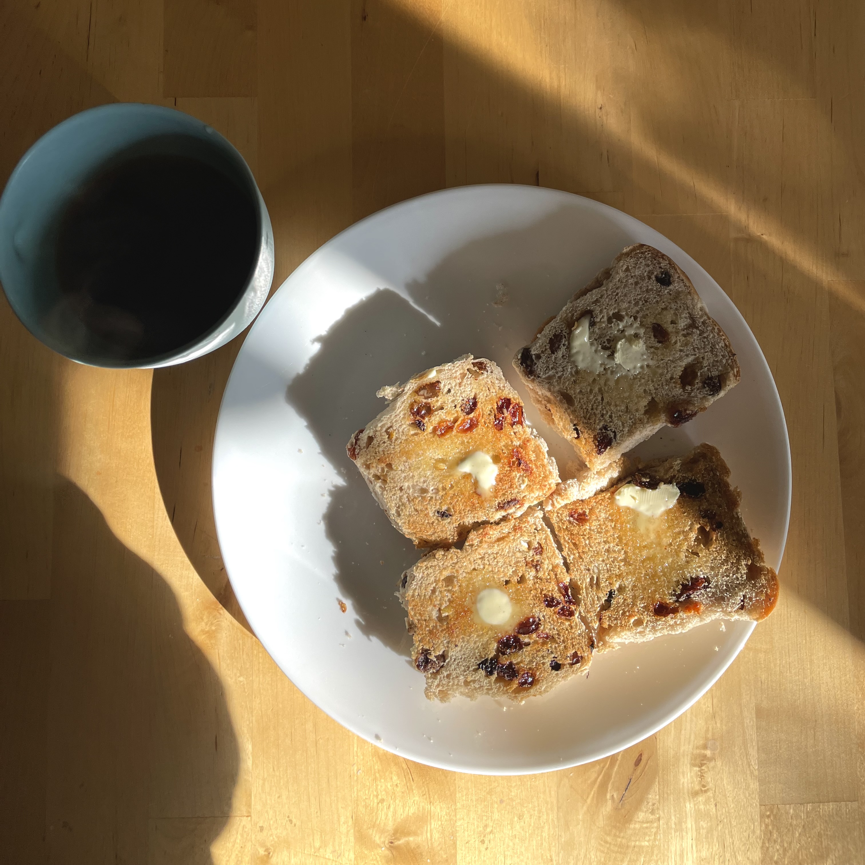 2 toasted and buttered hot cross buns and a cup of coffee