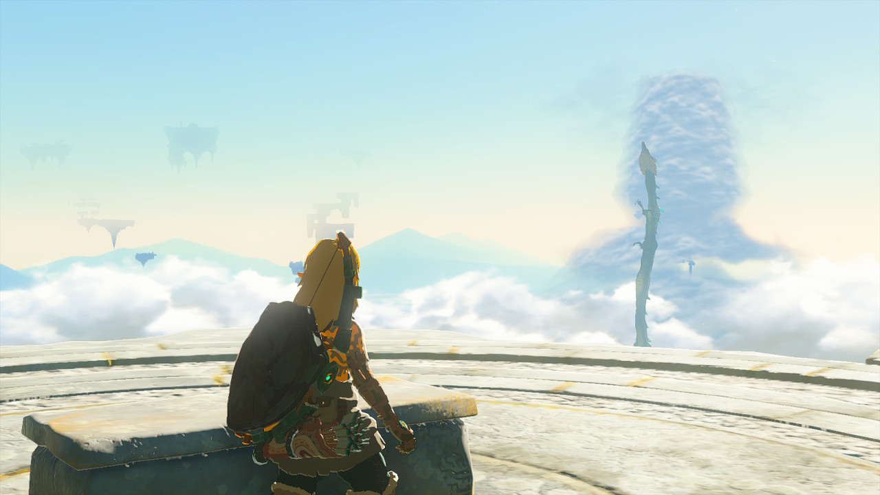 Link looking out at a sky-scape consisting of a number of distant sky-islands and a dragon flying upward