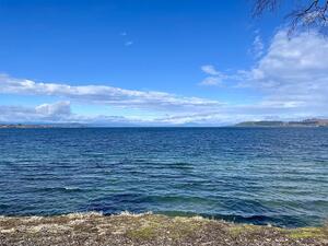 The view of Lake Taupō from town, looking towards Mt Tongariro in the south