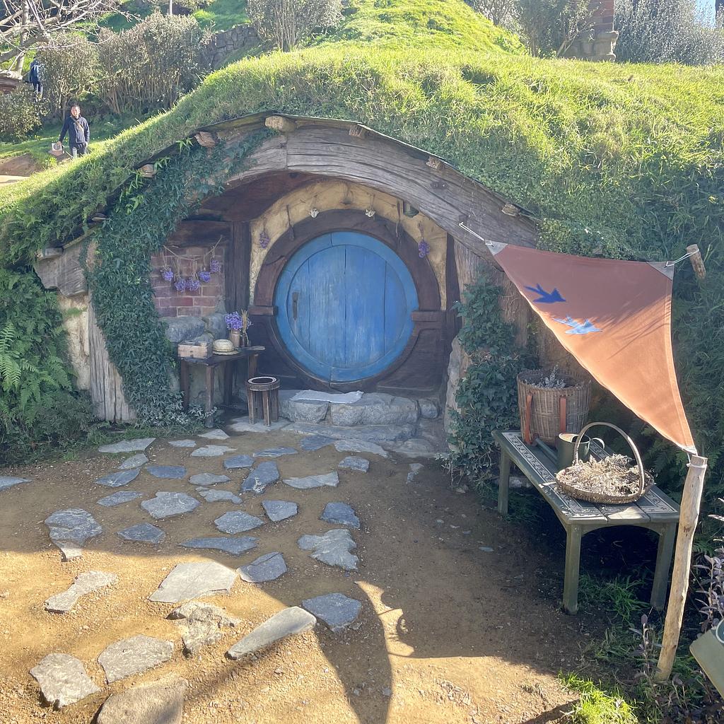 A Hobbit hole with a dark blue door