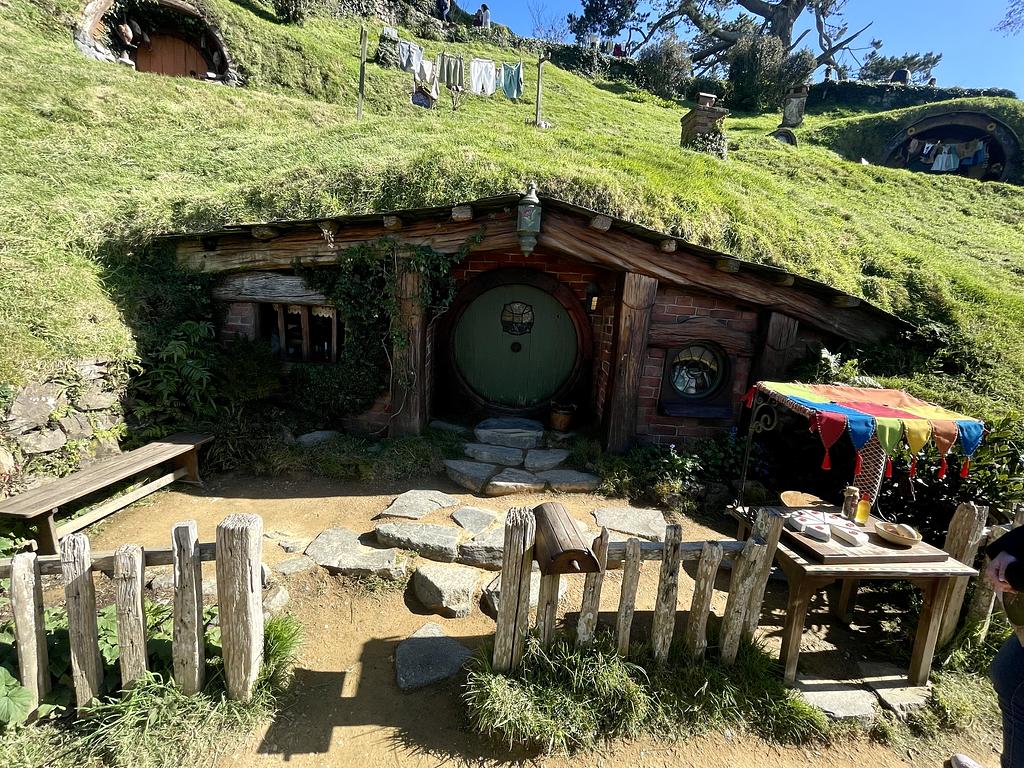 A Hobbit hole with a green door 