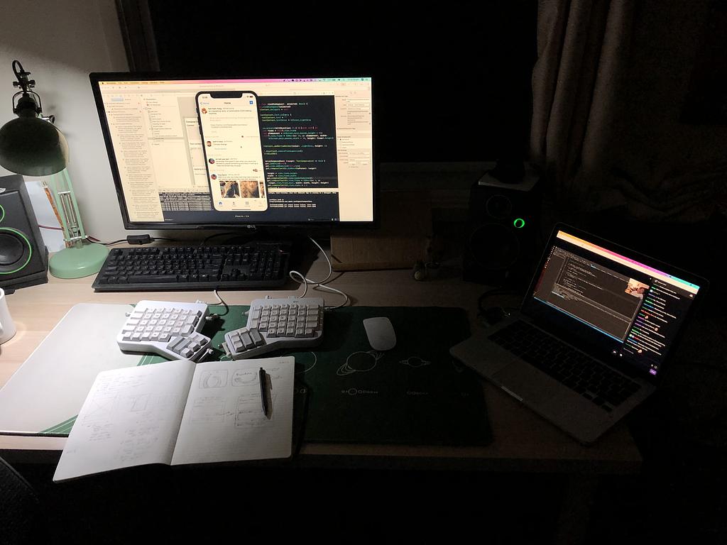 The same desk as above, at night, working on an iOS app